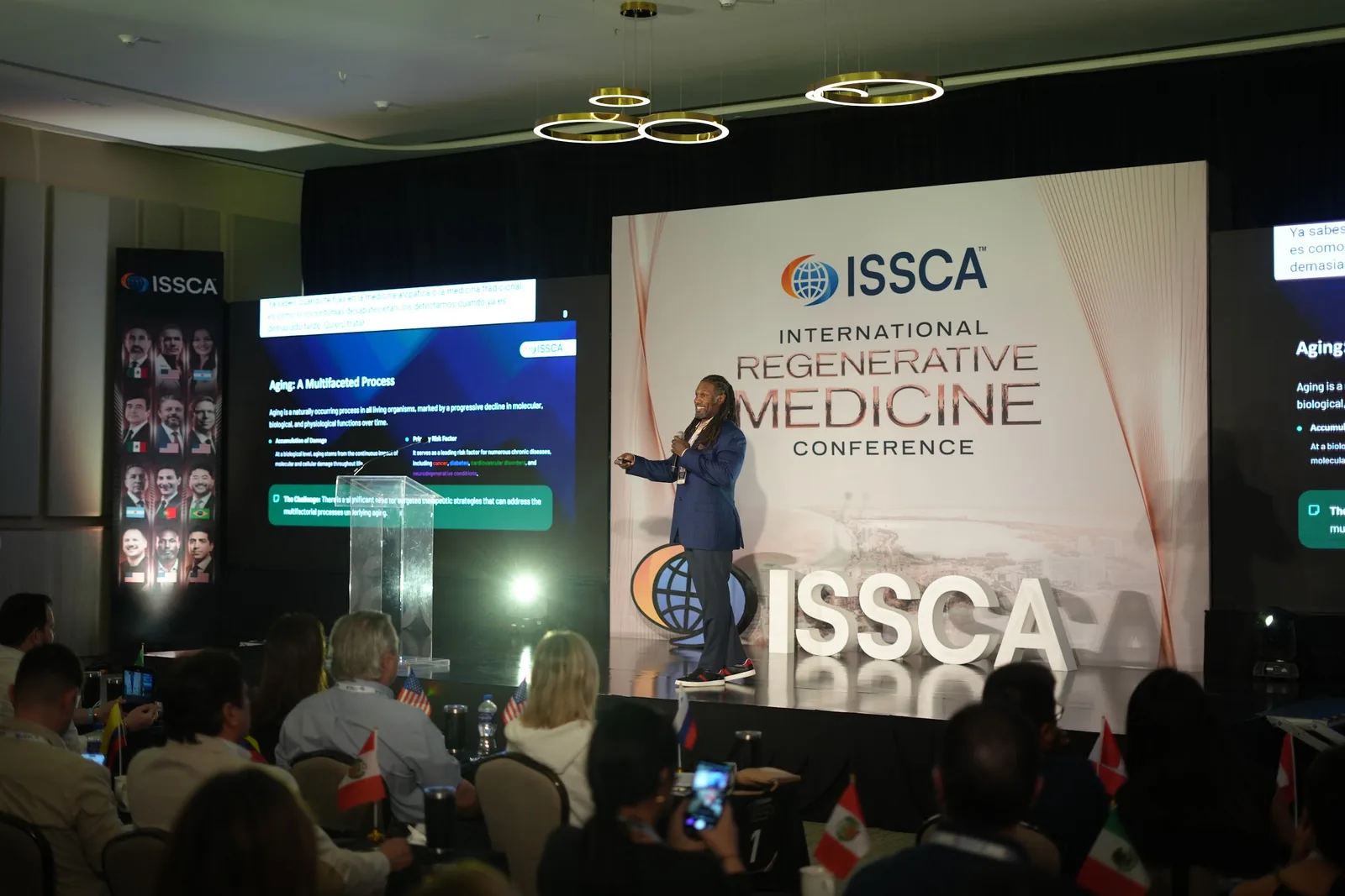 A speaker presenting on the ISSCA main stage at ISSCA 112 in Cancún, with physicians from many countries in the audience