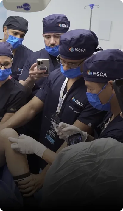 ISSCA physicians in scrubs during a hands-on ultrasound practice session